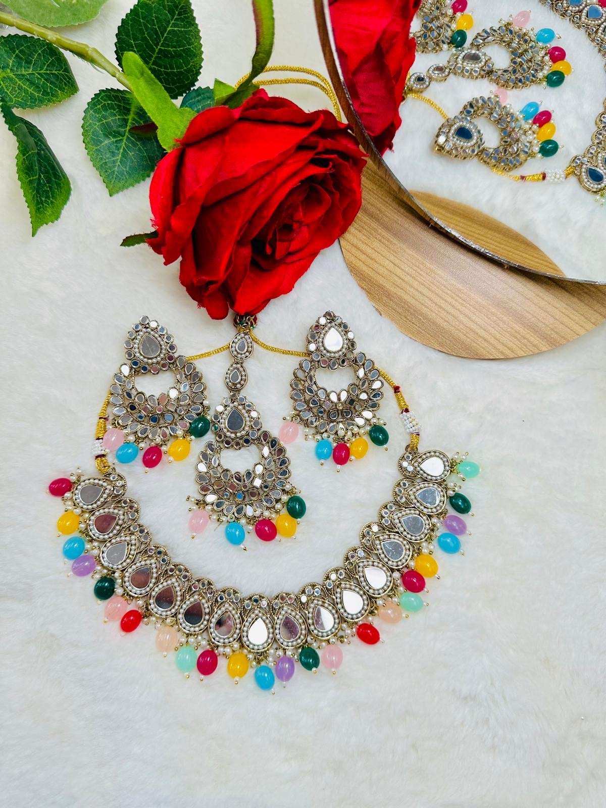 Mirror set with earrings and tikka.