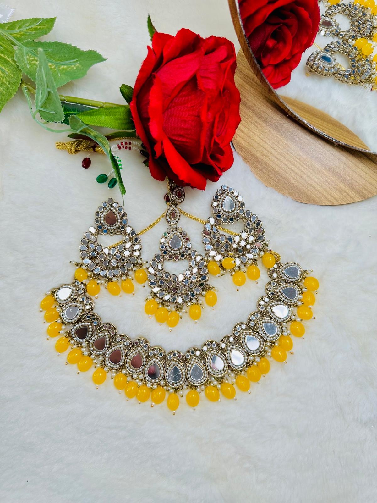 Mirror set with earrings and tikka.