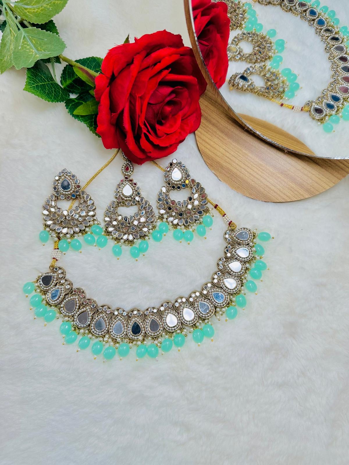 Mirror set with earrings and tikka.