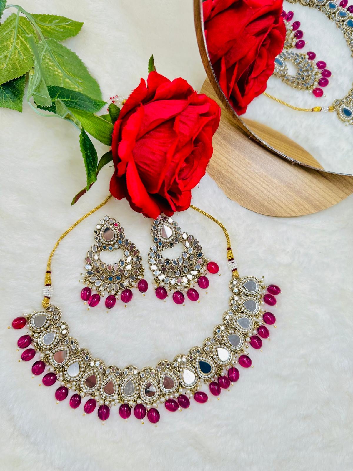 Mirror set with earrings and tikka.